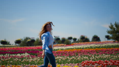 Happy-woman-profile-running-in-flower-garden-in-slow-motion-in-spring-sunny-day.