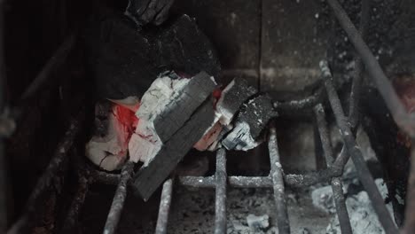 4k at 60fps (slow motion) - burning coal on a rusty grill on a sunny day - relax and warm mood