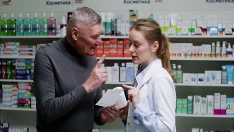 young woman talking with senior man at the pharmacy