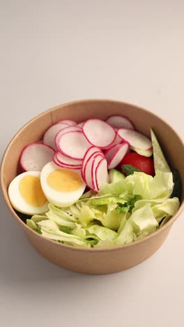 healthy vegetable salad in paper bowl