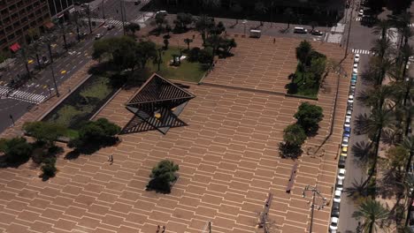 aerial view of a city plaza with sculptures and trees