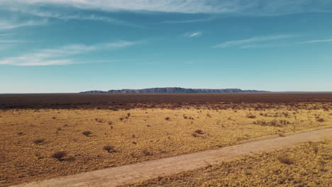 A-drone-showcasing-a-beautiful-deserted-road-in-the-southern-province-of-Mendoza,-Argentina