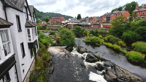 flowing river beside buildings and greenery