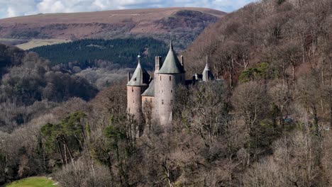 stunning drone footage of castell coch near cardiff, showcasing its fairytale architecture, lush woodland setting, and historic charm through cinematic aerial and scenic shots.