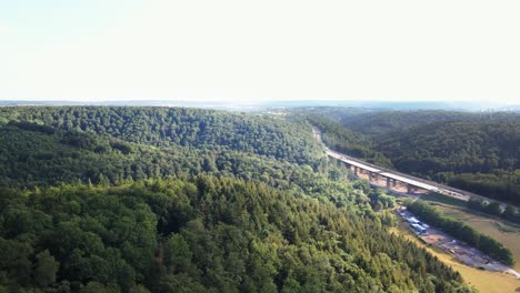 Aerial:-Drone-flight-towars-beautiful-highway-Bridge-,-surrounded-by-forrest,-in-the-region-of-Saarland,-Germany