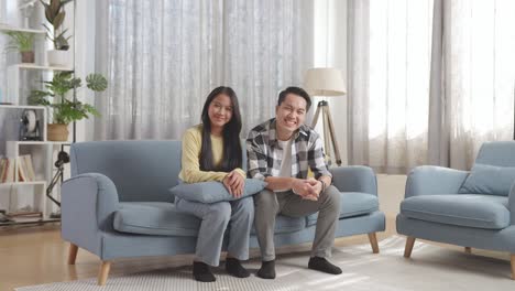 happy couple sitting on a sofa