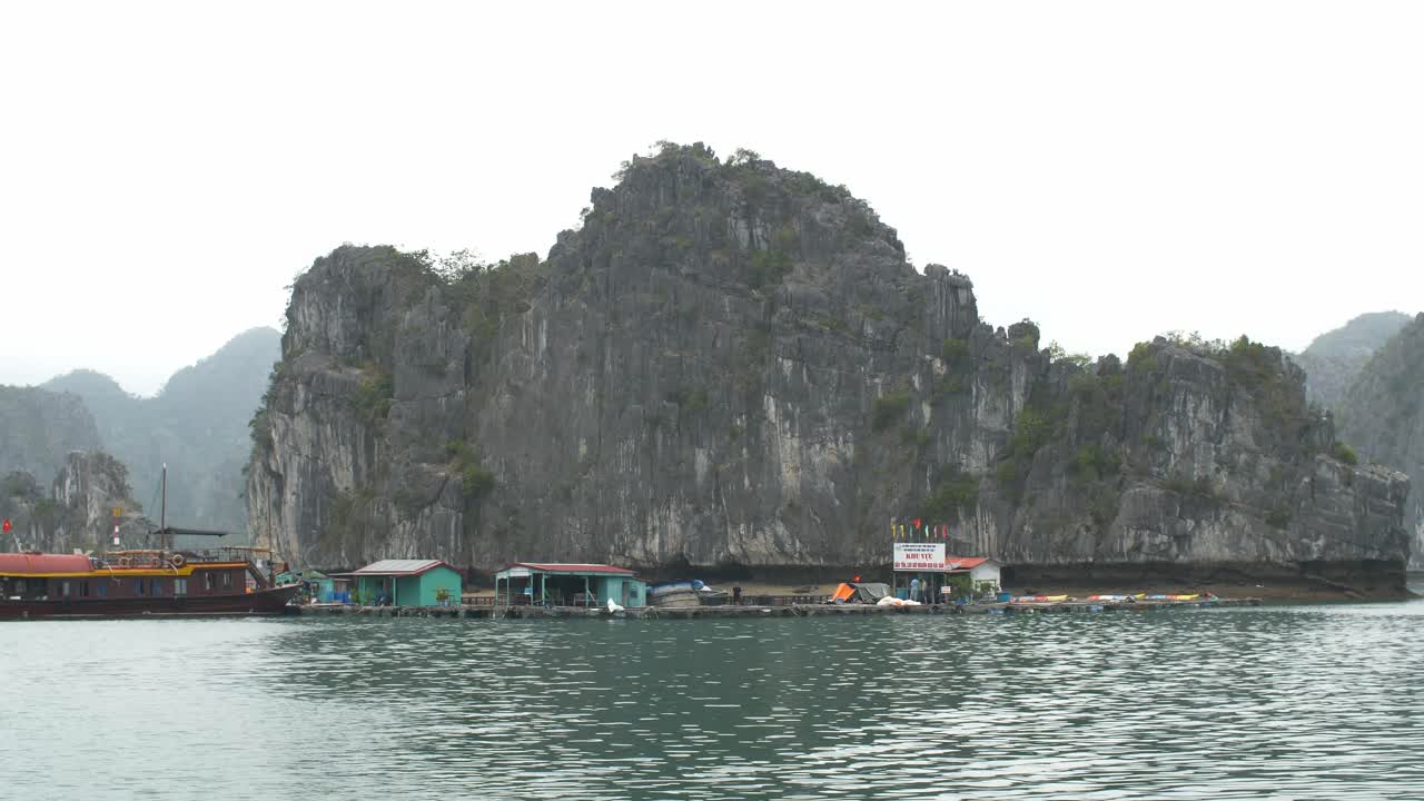 Ha Long Bay fish farm with stunning limestone cliffs, tranquil mood