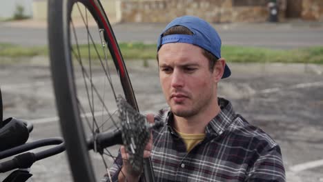 disabled man looking at the wheel of his chair