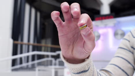 Close-up-of-white-caucasian-male-hand-showing-a-small-microchip-to-the-camera