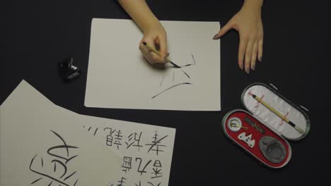 person practicing calligraphy