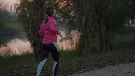 woman jogging outdoors by a river