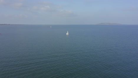 Aerial-view,-4K,-approaching-shot,-two-sail-boats-out-at-sea