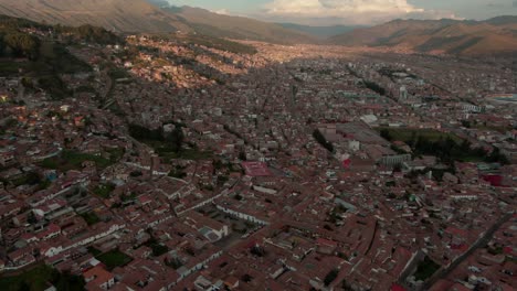 4k aerial drone panoramic view during the daytime, before sunset of the central cusco, capital of the inca, with a zoom in over the plaza de armas