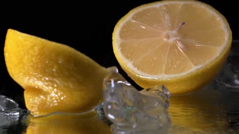 Lemon-cut-in-half-being-sprayed-with-water-and-surrounded-by-ice