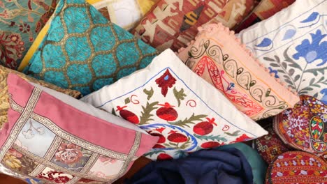 assortment of embroidered and patterned pillows