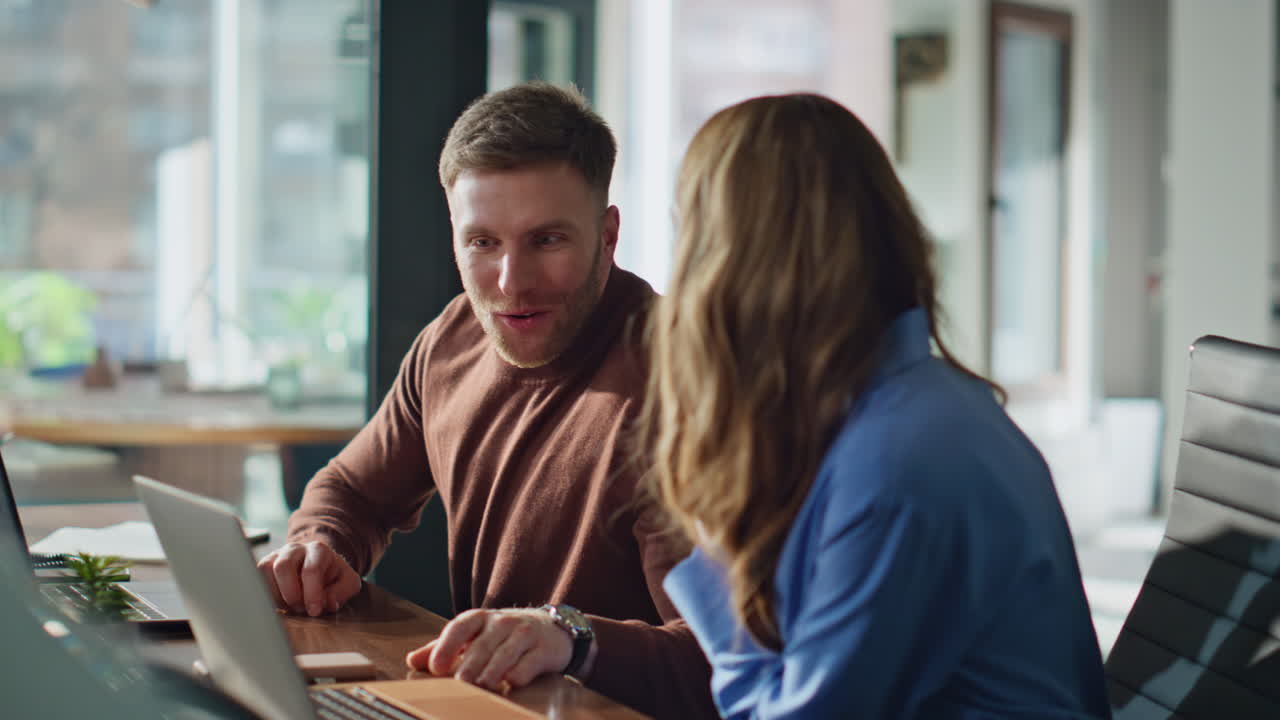 Successful startupers rejoicing achievement at modern workplace closeup