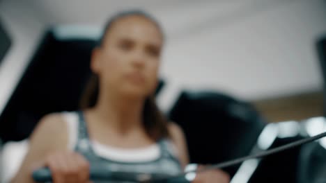 Close-Up-shot-of-Woman-Using-Rowing-Machine