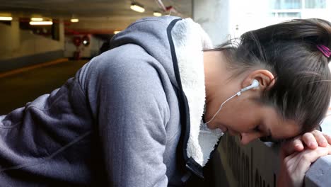 woman taking break at underground car parking lot 4k