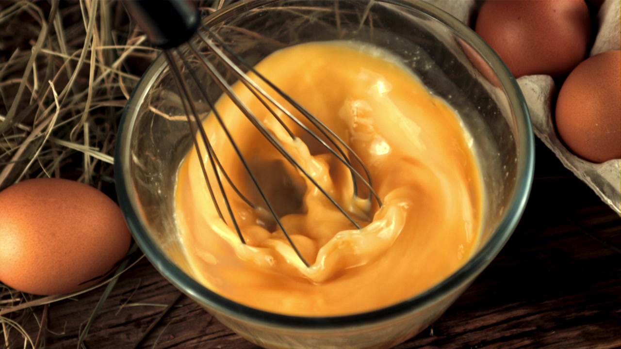 Super Slow Motion of Whisk Mixing Egg Yolks in a Glass Bowl