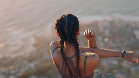 young-woman-with-arms-raised-on-mountain-top-celebrating-achievement-girl-on-edge-of-cliff-looking-at-beautiful-view-at-sunset-enjoying-travel-adventure