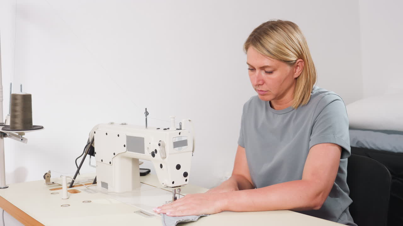 Costumer on chain stitch machine, stitching garment, carefully guiding fabric, ensuring precise seams, focusing on professional technique, maintaining quality, creating fashionable design