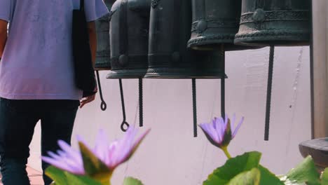 close of people ringing big metal bells