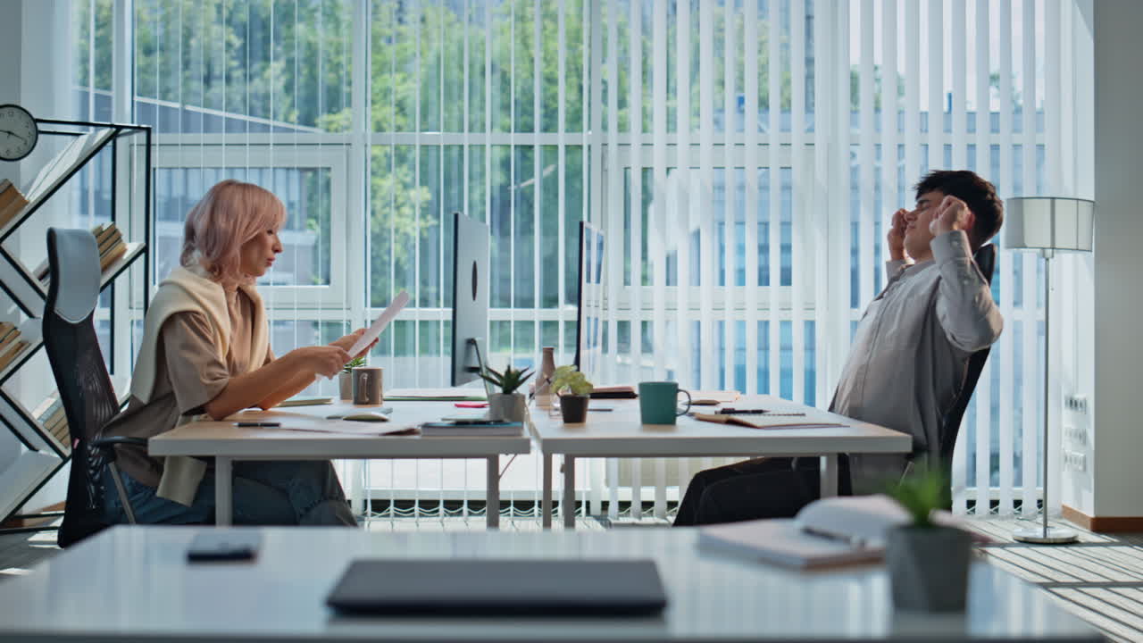 Office workers sitting table solving tasks at panoramic interior. People working