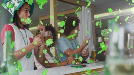 animation of clover icons over diverse friends drinking beer