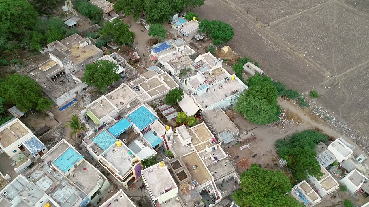 Aerial view of tightly packed Indian Village during morning time near the agriculture field