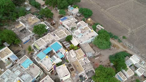 Aerial-view-of-tightly-packed-Indian-Village-during-morning-time-near-the-agriculture-field