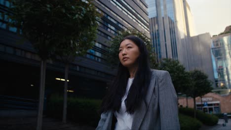 business chinese woman walking the city street