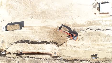 Top-View-of-Excavator-and-Trucks-in-construction-Site