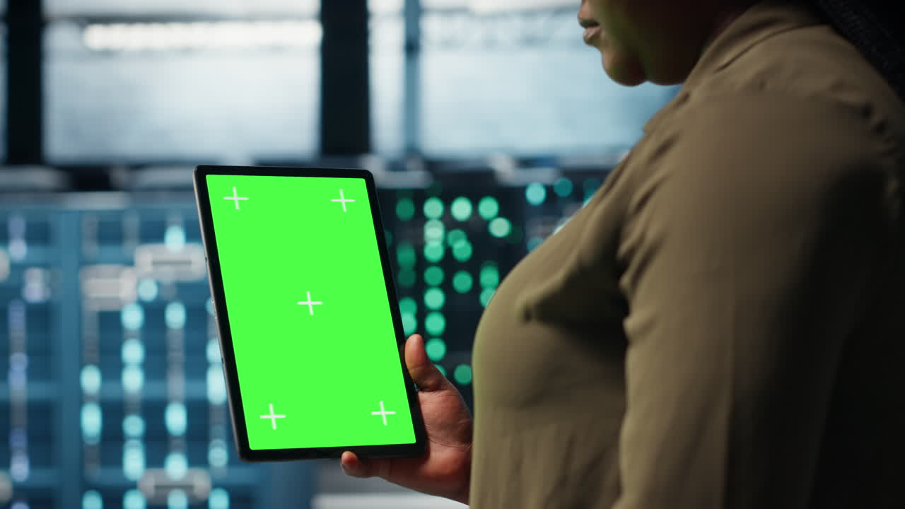 Admin with isolated screen tablet in data center doing power management