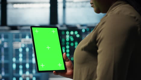 admin with isolated screen tablet in data center doing power management