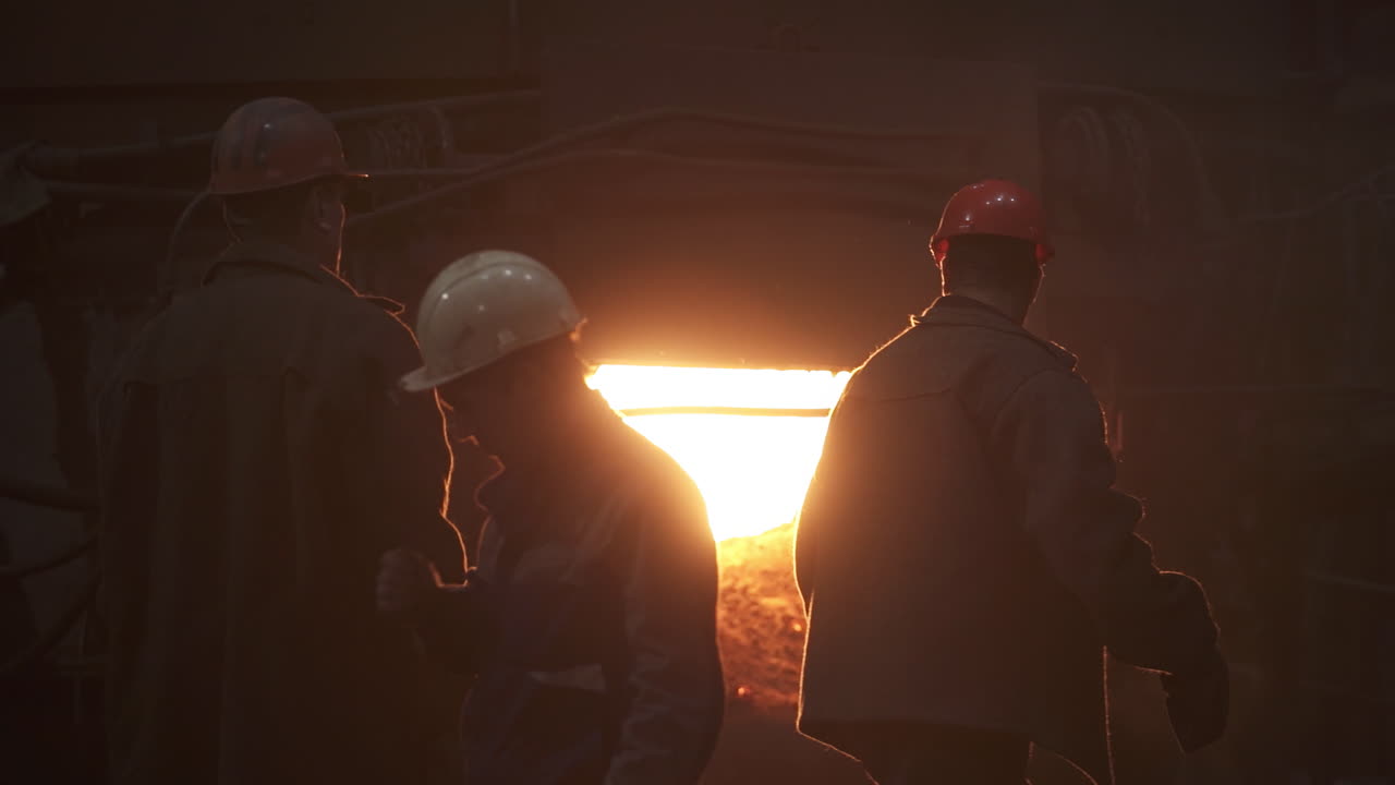 Steel Workers Observing a Furnace