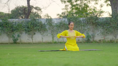 Indian-girl-doing-breathe-in-breathe-out-yoga-exercise