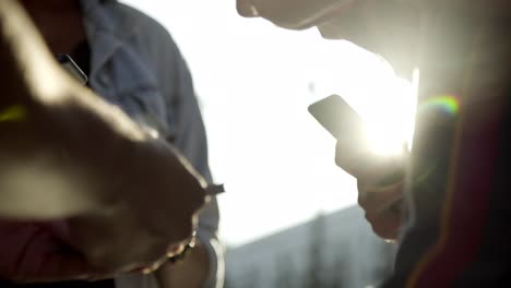 closeup shot of young people holding smartphones