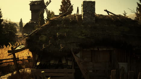 rustic countryside cottage with thatched roof against golden sunset sky