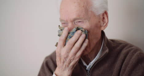 senior man has cold snot and sneezing