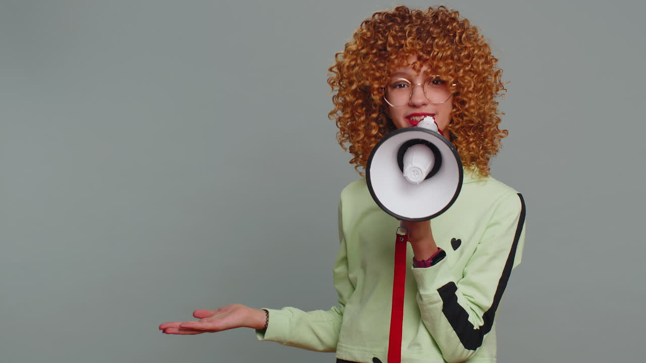 Teenager girl scream shout in megaphone loudspeaker announces discount sale announcing advertisement