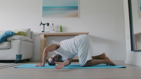 40-year-old-Middle-Eastern-man-does-morning-yoga-at-home-before-the-kids-wake-up