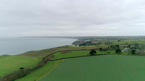 aerial tracking over fields and coastal landscape in the fertile area of south devon, near dartmouth