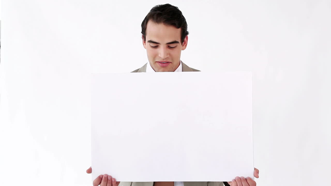 Businessman holding a blank poster