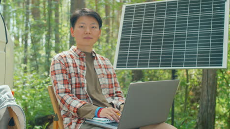 asian ecologist with laptop portrait