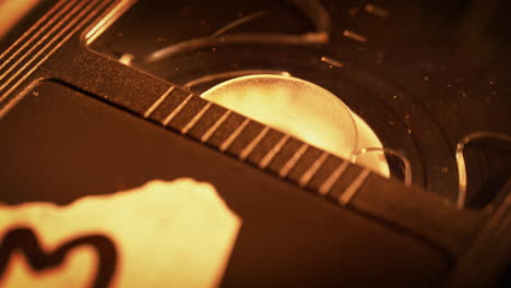 labeled vhs video cassette is inserted into the vcr, the tape winds onto the take-up reel - macro, 90s vibe