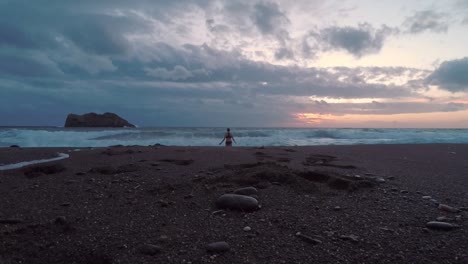 una mujer nadando en el mar salvaje durante la puesta de sol