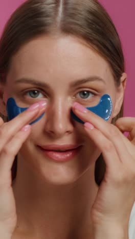 woman applying eye patches