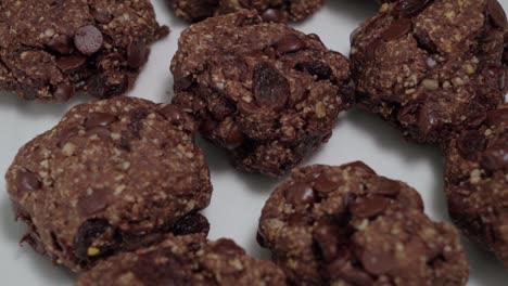 tilt up of oatmeal raisin cookies on white background, closeup detail