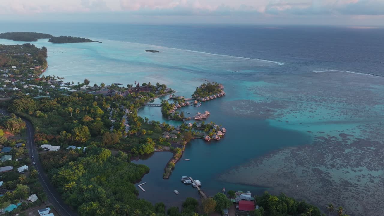 Bungalow villas car morning islands Cooks Opunohu Bay Moorea French Polynesia aerial drone Mount Mauaroa Tohivea Rotui clouds lagoon coral reef vibrant green blue Pacific Ocean forward pan up motion