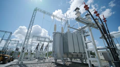 high voltage transformer against the blue sky. electric current redistribution substation